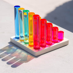 Colorful test tubes on a white base with a light background
