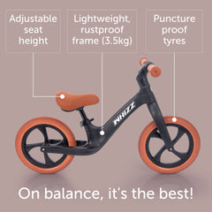 Balance bike with features highlighted on a beige background