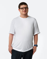 Person wearing a plain white t-shirt on a light gray background