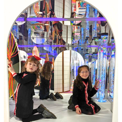 children in padded den with lights