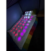 Colorful LED pillow with multicolor lights on a dark background