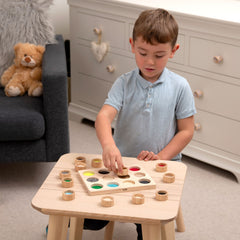 boy playing with touch and match board