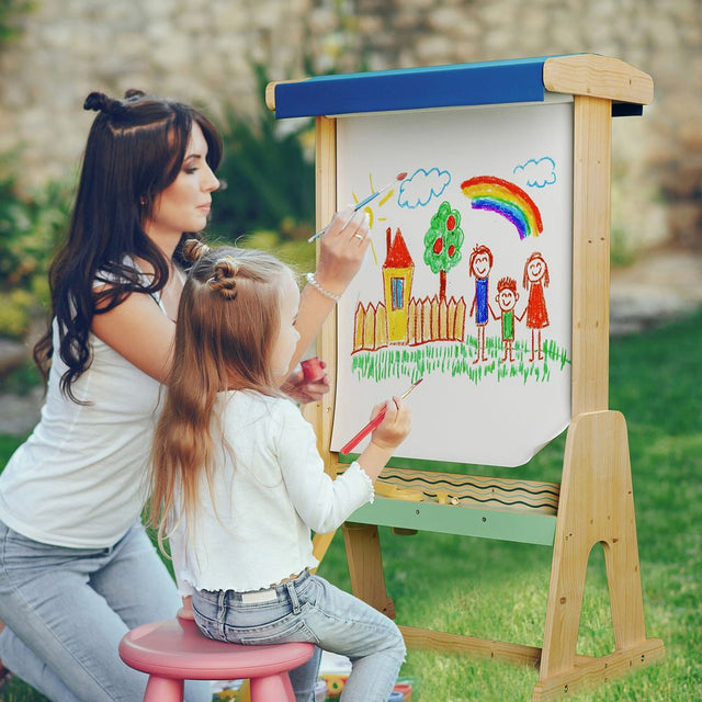 Woman and child drawing on a wooden easel outdoors