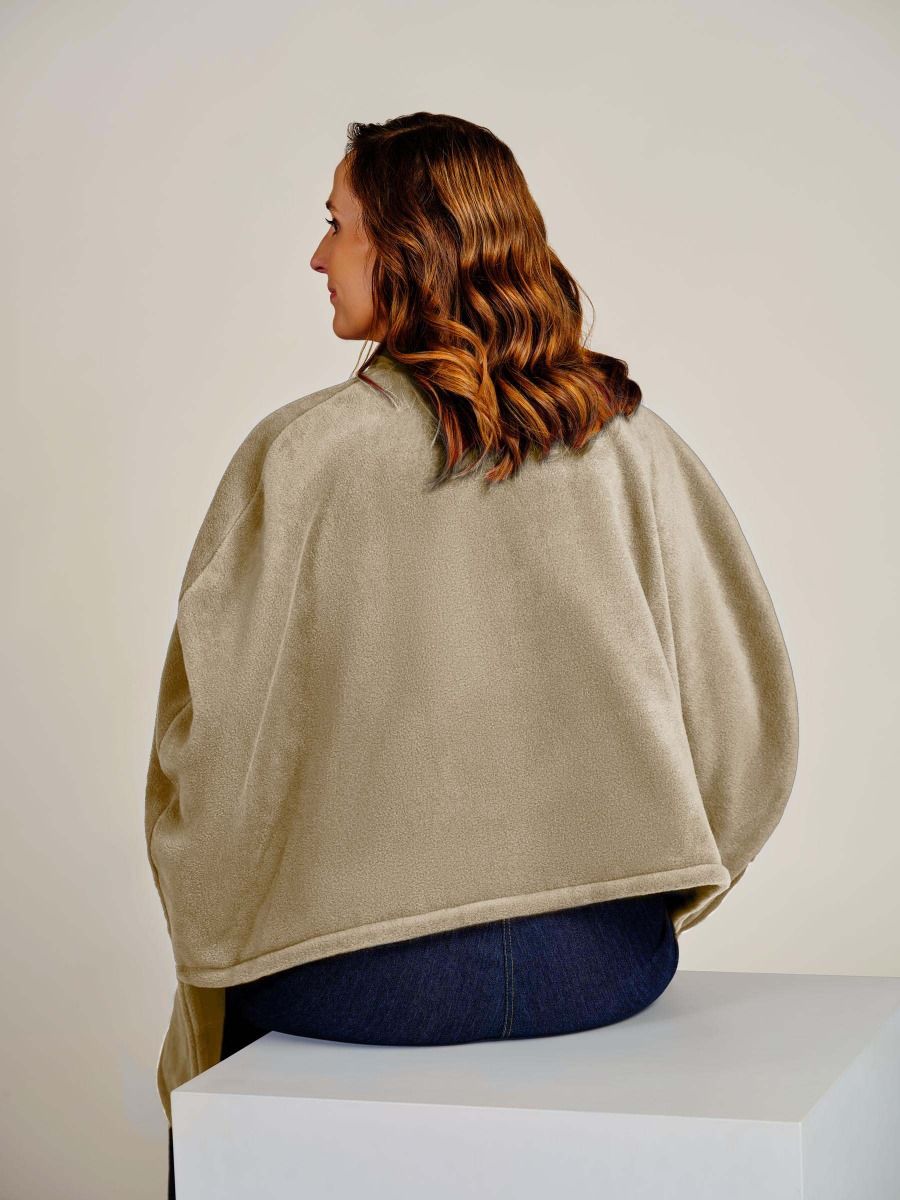 beige cpae on back of lady