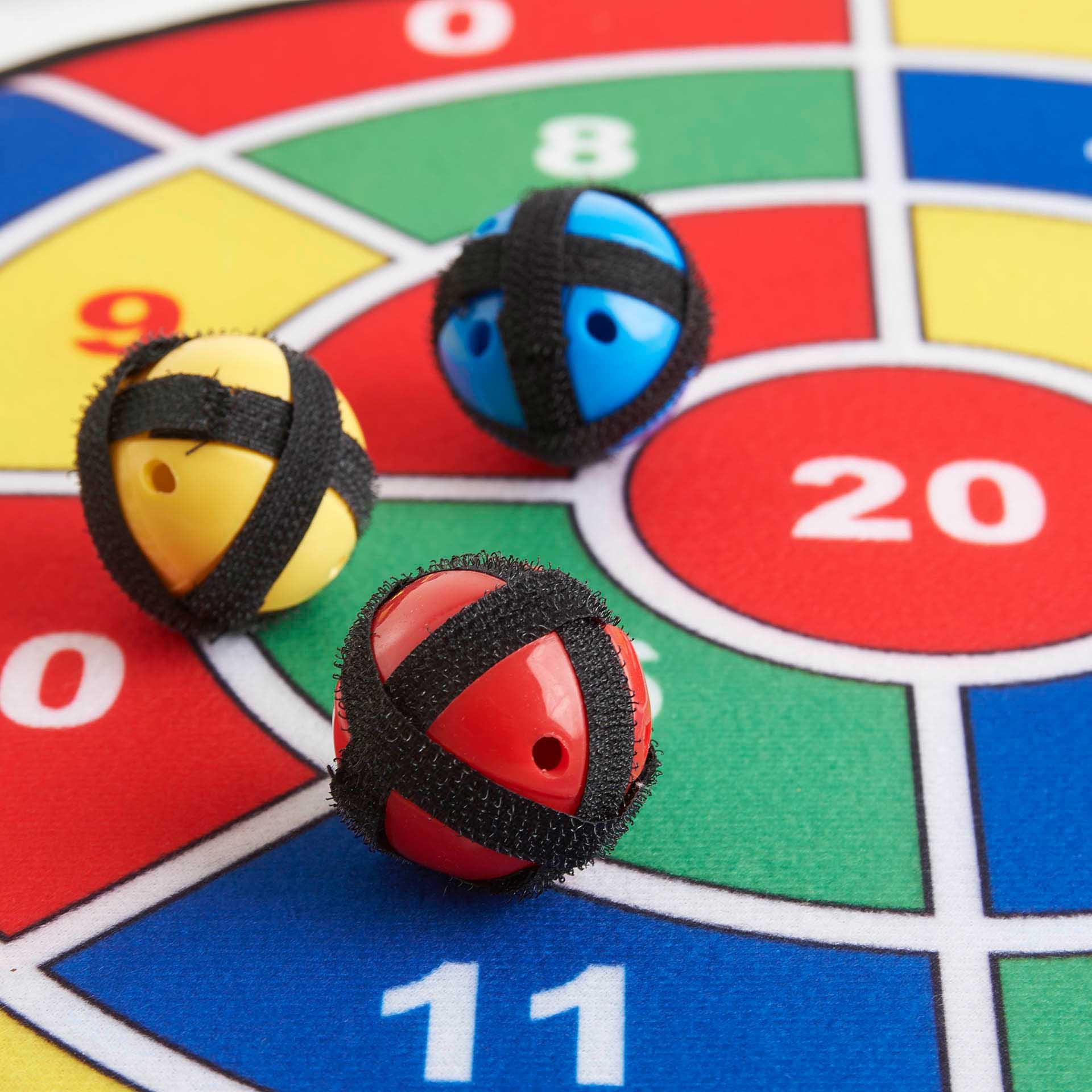 Three colorful darts on a game board with numbers