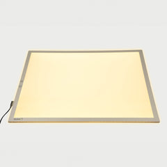 Rectangular light pad with a beige surface on a white background