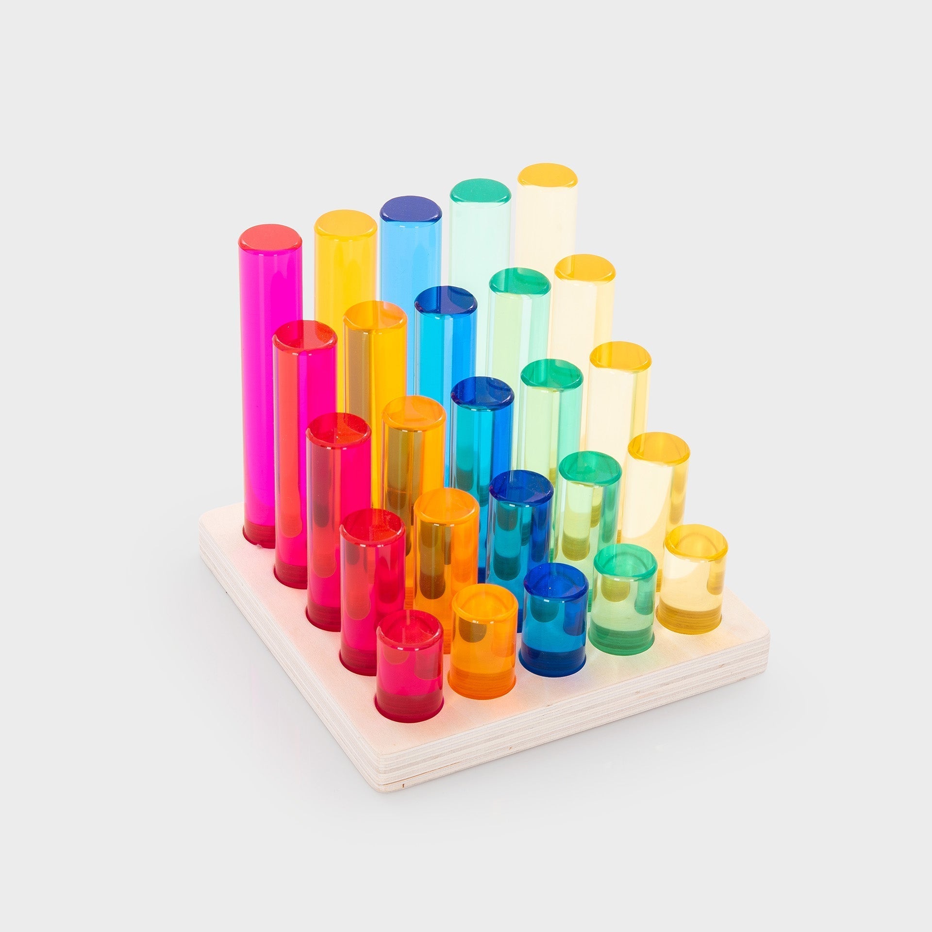 Colorful transparent cylindrical blocks on a wooden base against a white background