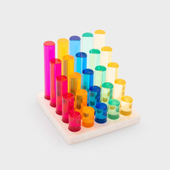 Colorful transparent cylindrical blocks on a wooden base against a white background