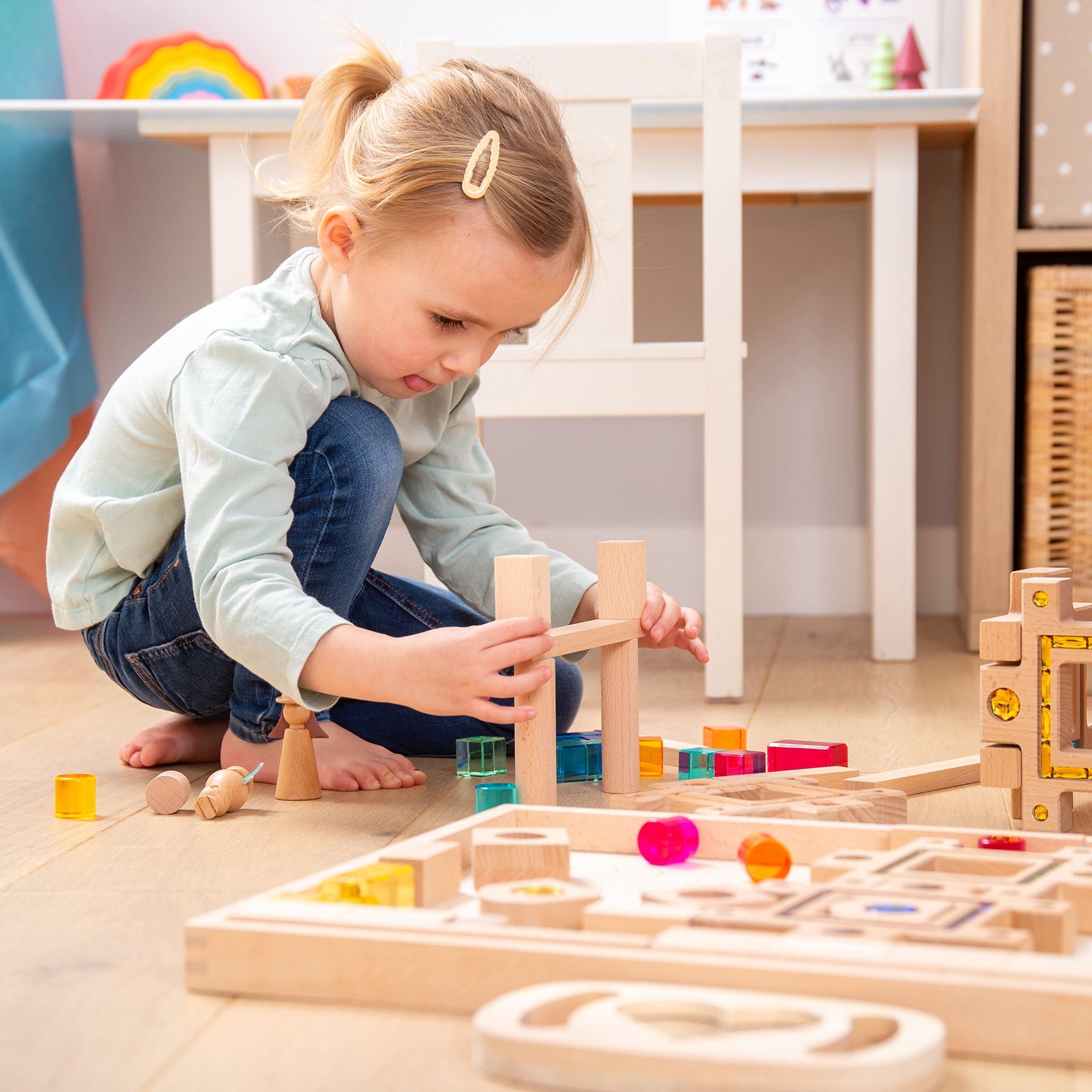 girl playing with set of tickit gem puzzle blocks