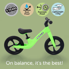 Green balance bike with features on a green background