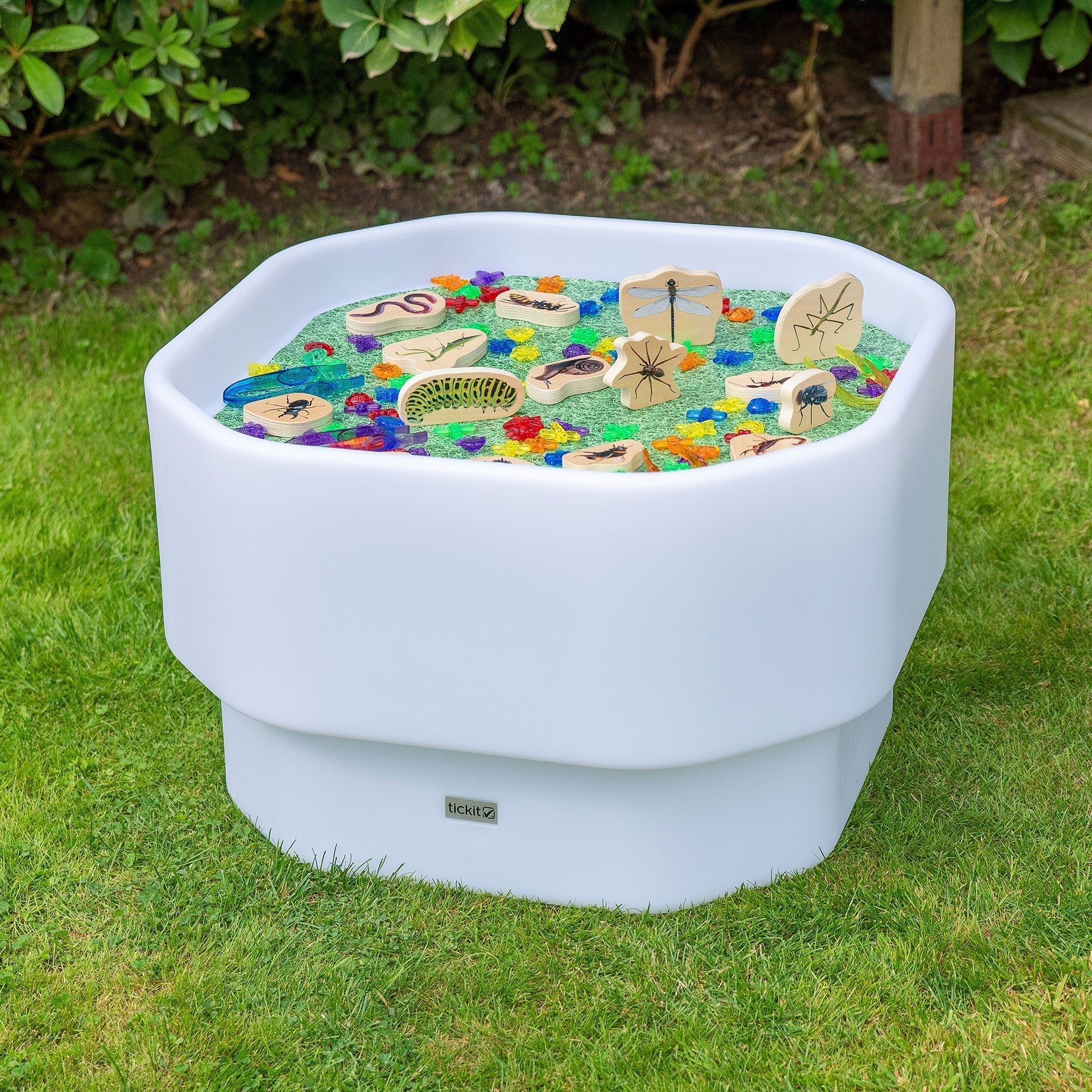 Decorative planter with colorful stones on a grassy lawn