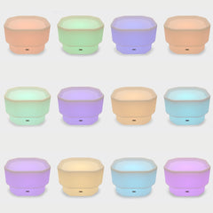 Set of colorful, collapsible discovery glow mini tuff tables in various pastel shades on a white background