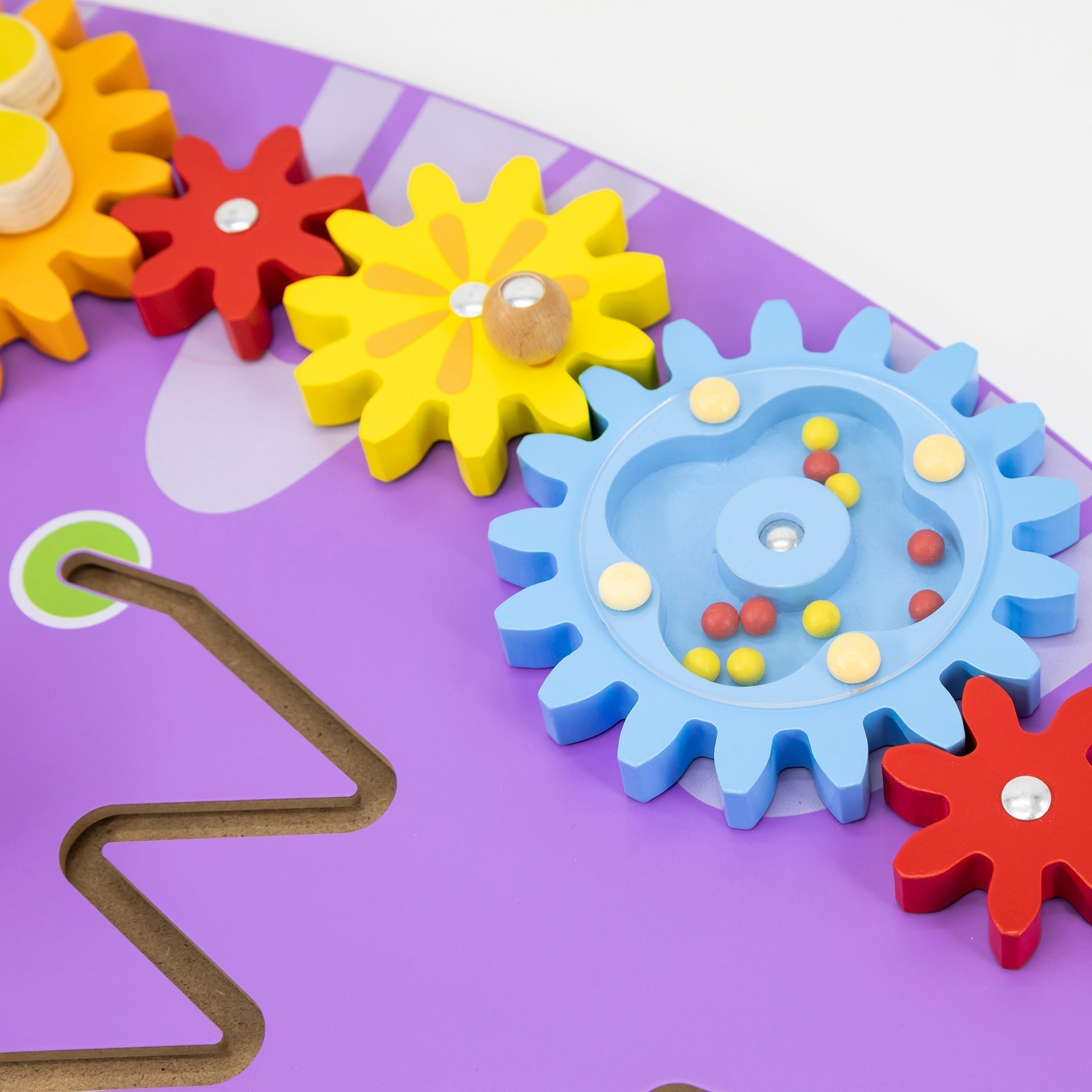 Colorful gear-shaped toys on a purple base