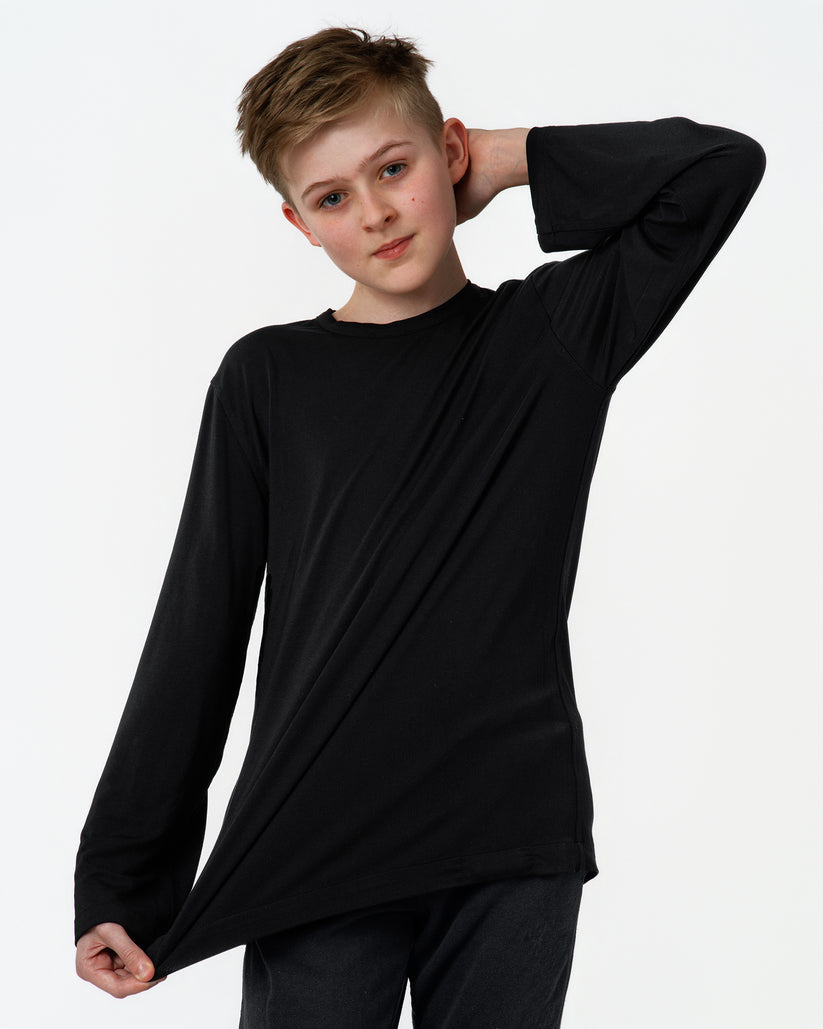 Child wearing a black long-sleeve shirt on a white background