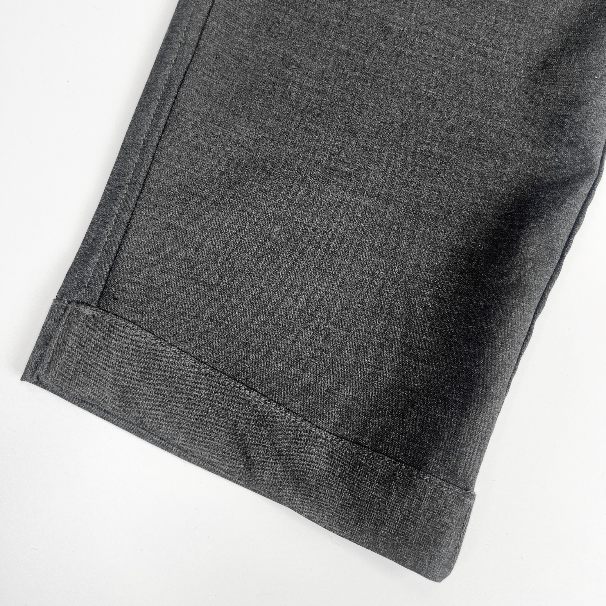 Close-up of gray pants on a white background