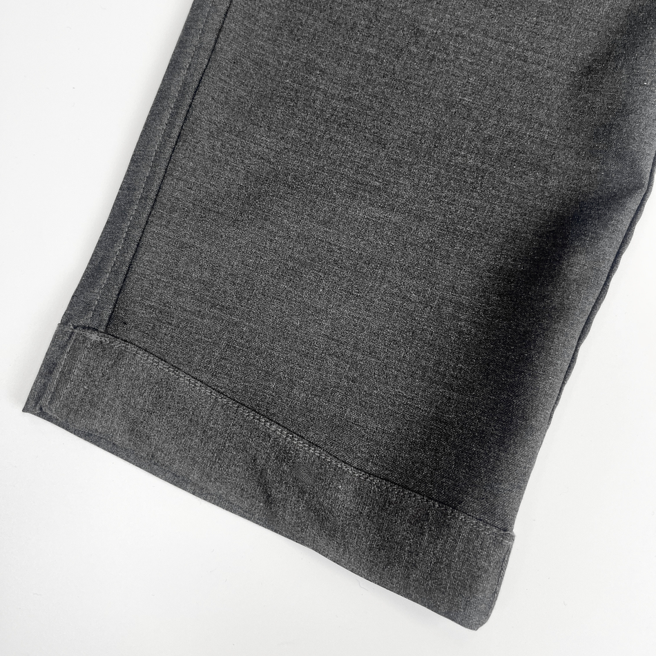 Close-up of gray pants on a white background