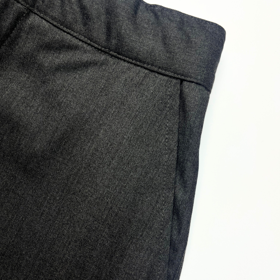 Close-up of dark gray pants on a white background