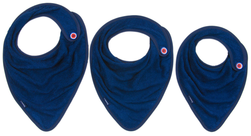 Three navy blue bibs in different sizes arranged side by side on a plain white background. Each bib has a small circular red and white logo near the collar.