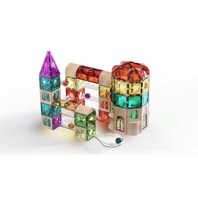 A colorful magnetic building toy set arranged to form a castle-like structure, with translucent blocks in purple, teal, green, orange, and red, plus a small clear ring and bead accessory on a white background.