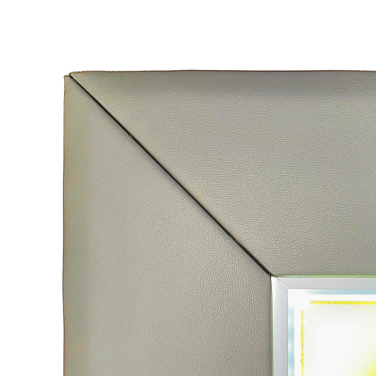 Close-up of the top-left corner of a square framed wall mirror with a textured light gray frame and a reflective silver border.