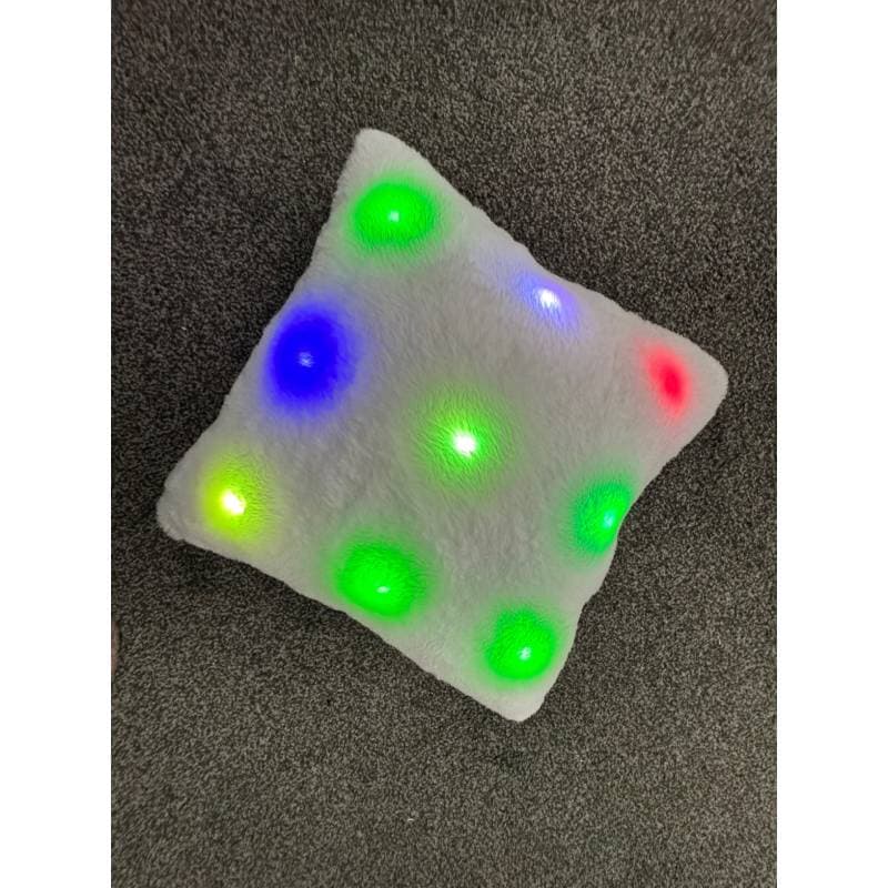 square pillow with colorful LED lights on a dark surface